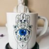 Caneca Mão De Fátima Hamsa Proteção Olho Grego